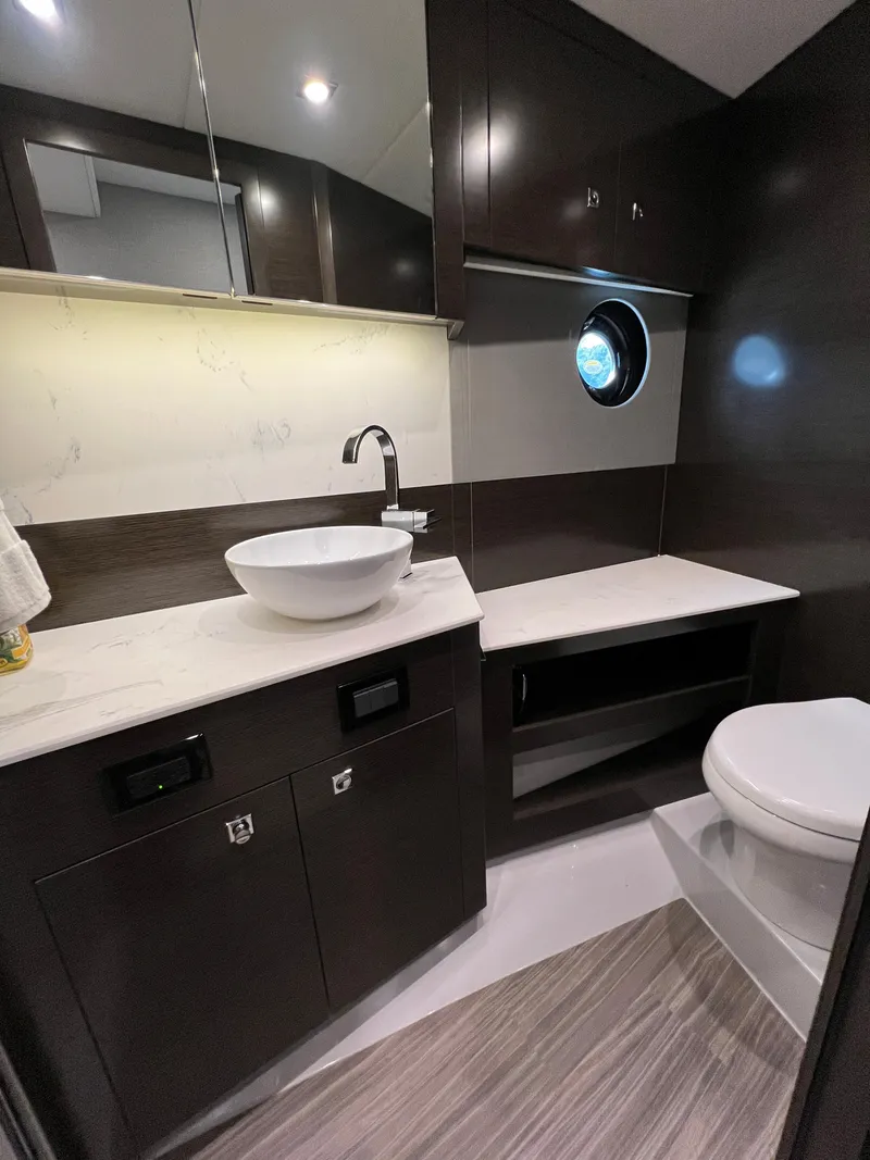 Slide: The Image of Modern bathroom in 2020 Cruisers Yachts 460 Cantius with sleek fixtures and porthole window. - 33