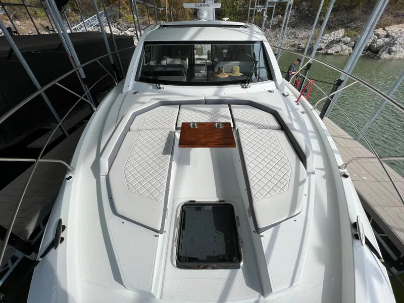 Slide: The Image of 2020 Cruisers Yachts 460 Cantius bow with sun pads and table. - 47