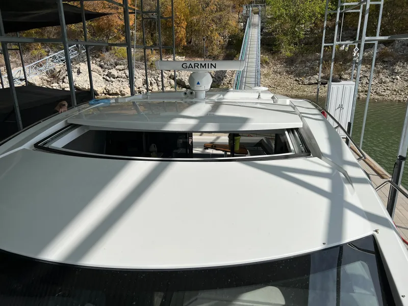 Slide: The Image of 2020 Cruisers Yachts 460 Cantius docked, featuring Garmin radar system. - 48