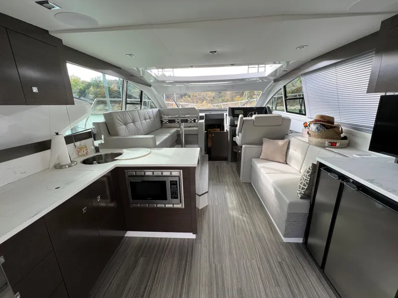 Slide: The Image of Modern interior of 2020 Cruisers Yachts 460 Cantius with kitchen and seating area. - 49