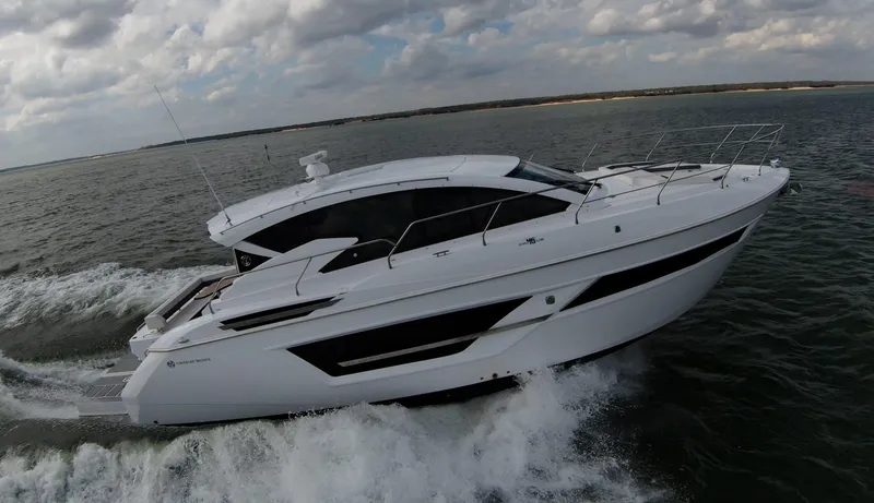 Slide: The Image of 2020 Cruisers Yachts 460 Cantius cruising on open water under cloudy sky. - 7