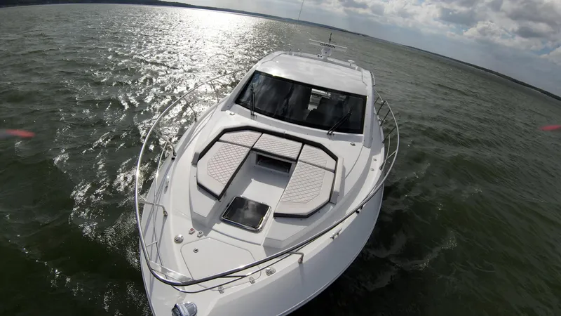 Slide: The Image of 2020 Cruisers Yachts 460 Cantius on open water under cloudy sky. - 8