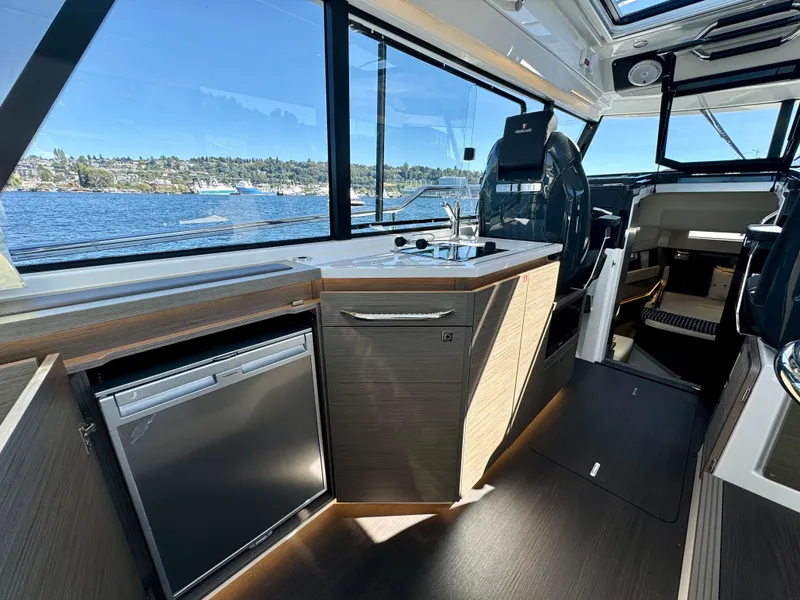 Slide: The Image of 2024 Wellcraft 355 boat interior with modern kitchen and scenic water view. - 15