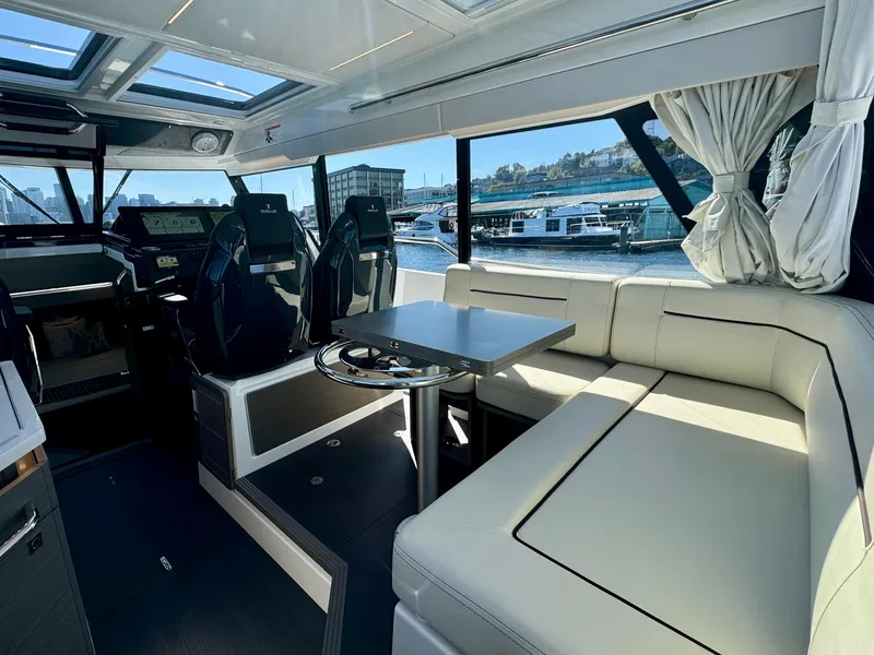 Slide: The Image of Luxurious interior of 2024 Wellcraft 355 yacht with seating and helm, docked at marina. - 16