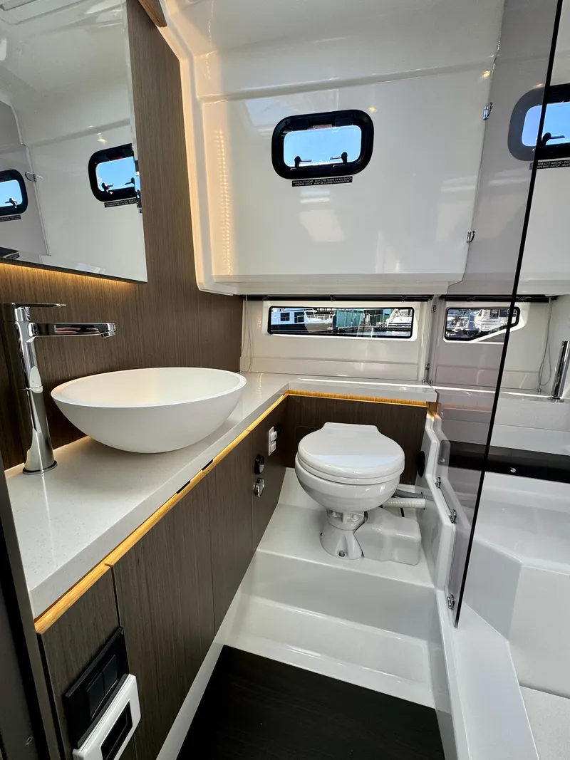 Slide: The Image of 2024 Wellcraft 355 yacht bathroom with modern sink and toilet. - 23