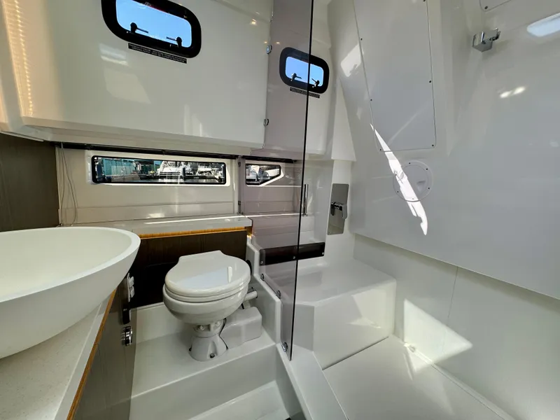Slide: The Image of 2024 Wellcraft 355 boat bathroom with modern fixtures and natural light. - 24
