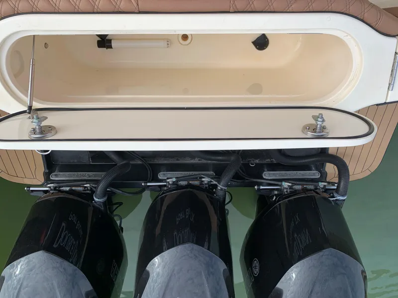Slide: The Image of 2018 Scout 350 LXF boat with triple outboard engines and open storage compartment. - 14