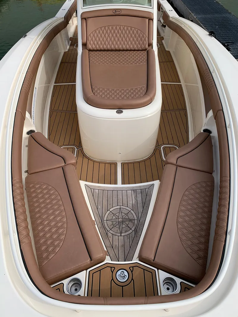 Slide: The Image of 2018 Scout 350 LXF boat interior with brown leather seating and teak flooring. - 16