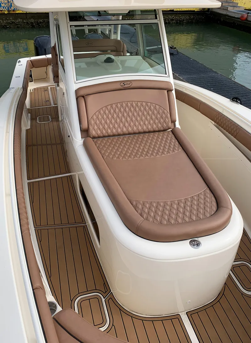 Slide: The Image of 2018 Scout 350 LXF boat with luxurious tan seating and sleek design. - 17