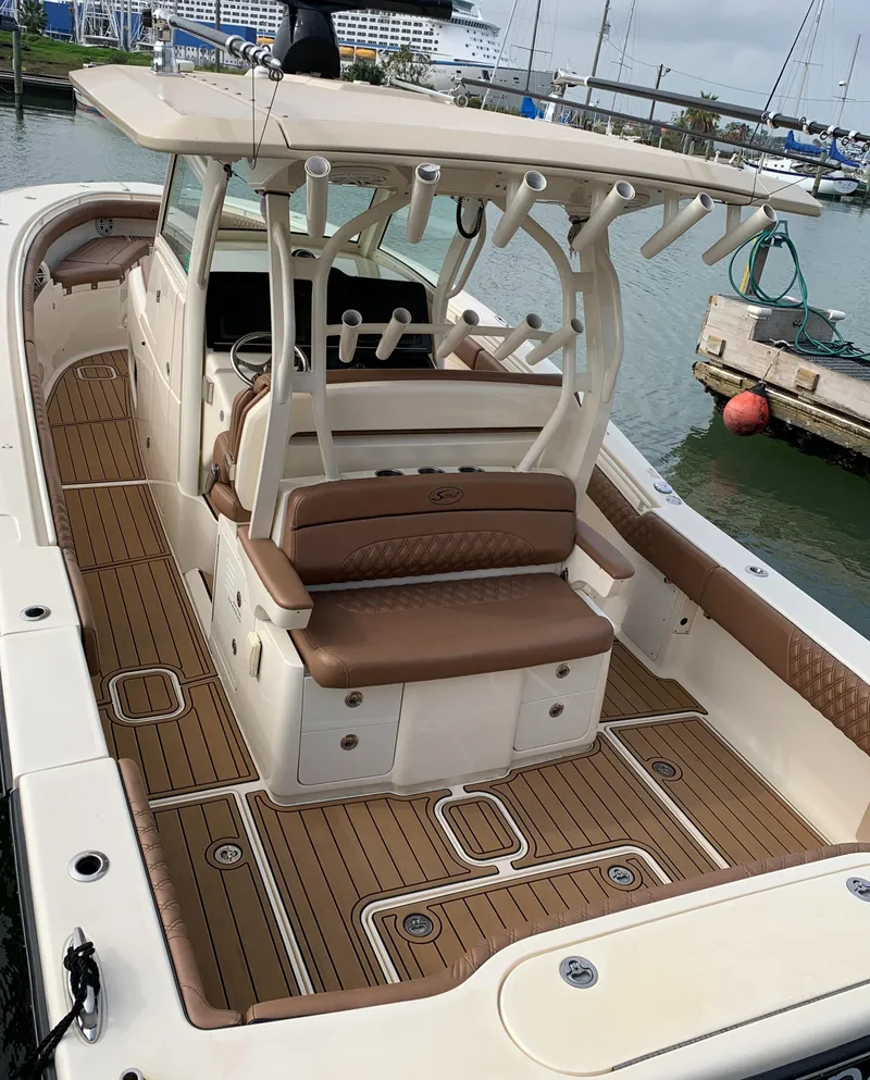 Slide: The Image of 2018 Scout 350 LXF boat with teak deck, docked in marina. - 2