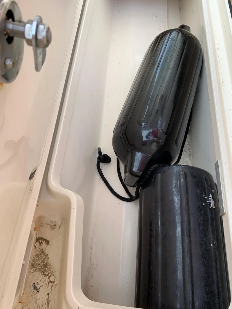 Slide: The Image of Boat storage compartment with black fenders, Scout 350 LXF, 2018 model. - 25
