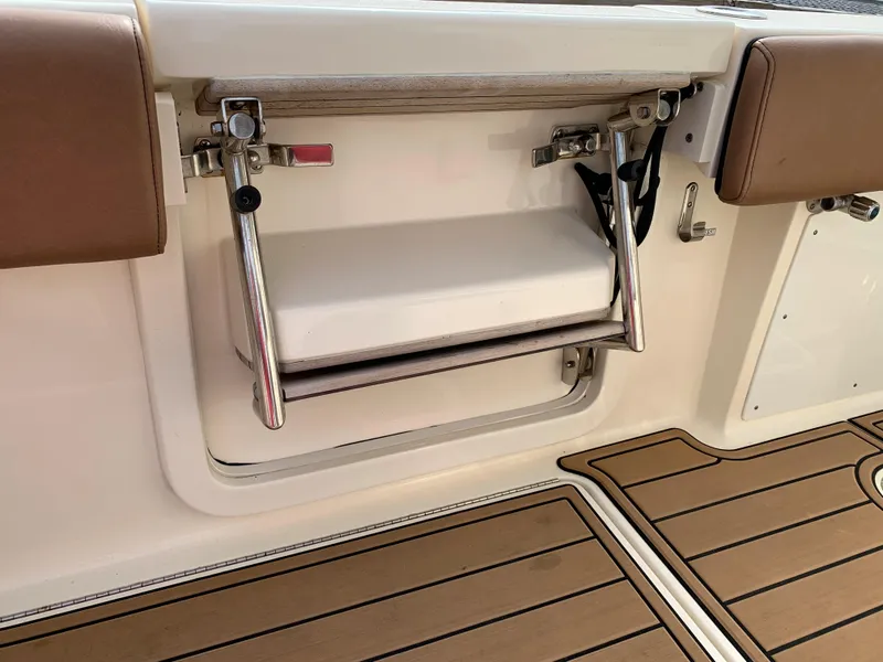 Slide: The Image of 2018 Scout 350 LXF boat interior with foldable seat and teak flooring. - 27