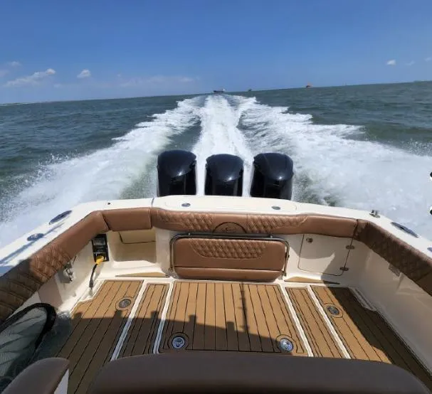 Slide: The Image of 2018 Scout 350 LXF boat cruising on open water, showcasing powerful engines and sleek design. - 3