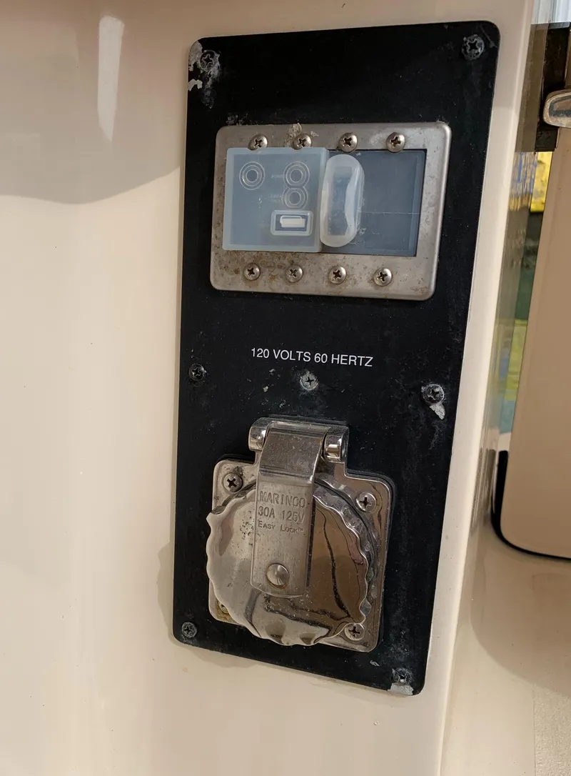 Slide: The Image of Electrical panel on 2018 Scout 350 LXF boat, featuring 120 volts, 60 hertz outlet. - 34