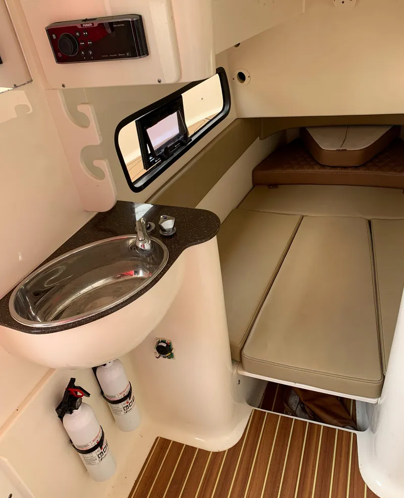Slide: The Image of 2018 Scout 350 LXF cabin interior with sink, seating, and wood flooring. - 37
