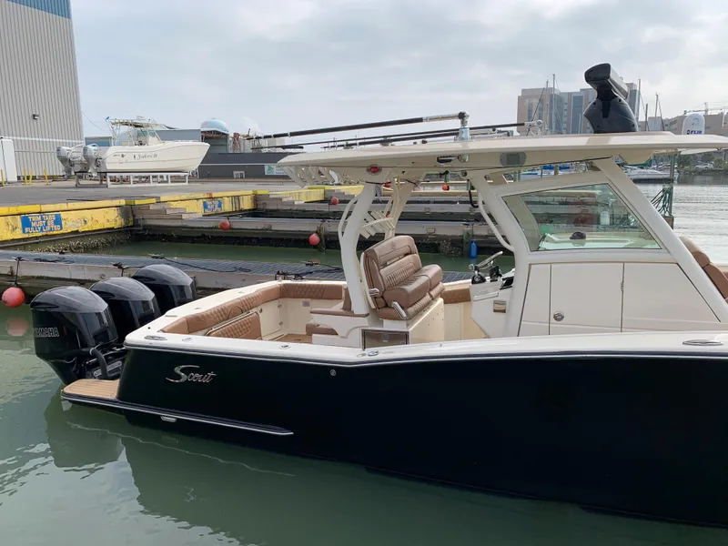 Slide: The Image of 2018 Scout 350 LXF boat docked at marina with triple outboard engines. - 4