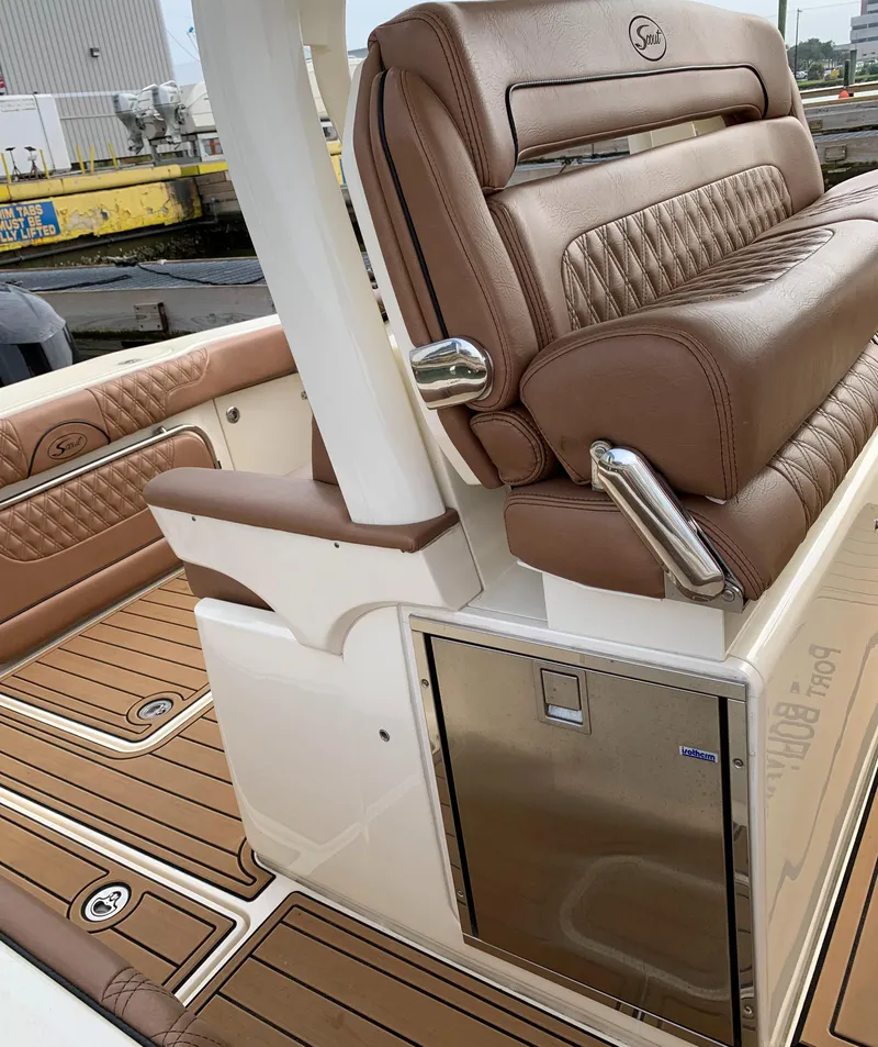 Slide: The Image of 2018 Scout 350 LXF boat interior with luxurious brown leather seating and teak flooring. - 41