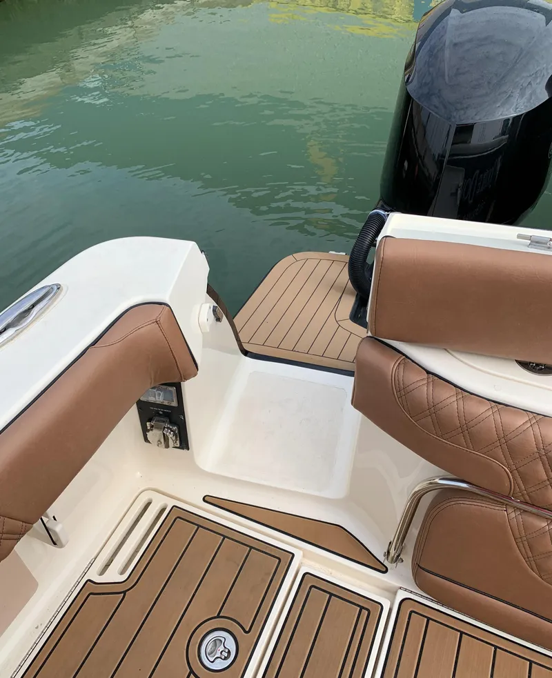 Slide: The Image of 2018 Scout 350 LXF boat interior with brown leather seating and teak flooring. - 43
