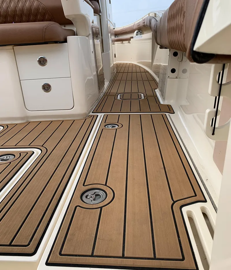 Slide: The Image of 2018 Scout 350 LXF boat interior with teak flooring and leather seating. - 44