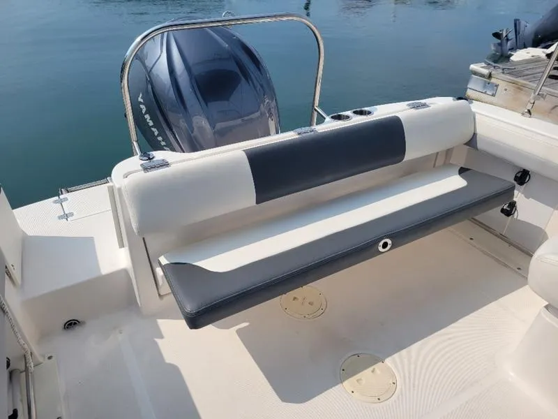 Slide: The Image of 2023 Robalo 227 DC boat interior with Yamaha engine, featuring a comfortable rear bench seat. - 10