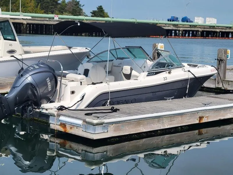 Slide: The Image of 2023 Robalo 227 DC boat docked with Yamaha outboard motor. - 12