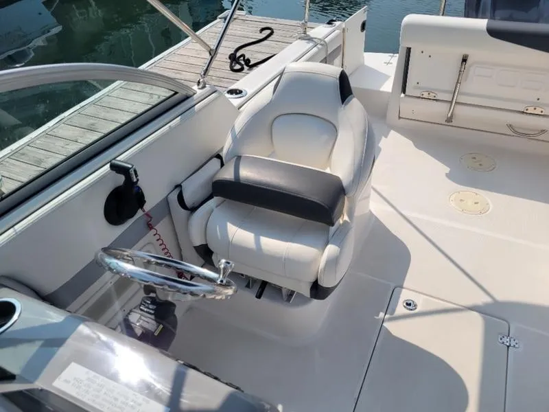 Slide: The Image of 2023 Robalo 227 DC boat interior with helm seat and steering wheel. - 14