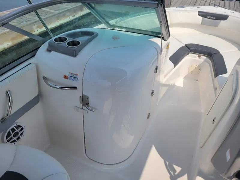Slide: The Image of 2023 Robalo 227 DC boat interior with seating and storage compartment. - 15