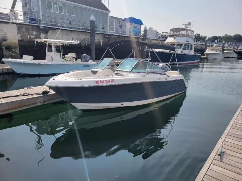 Slide: The Image of 2023 Robalo 227 DC boat docked in a marina. - 4