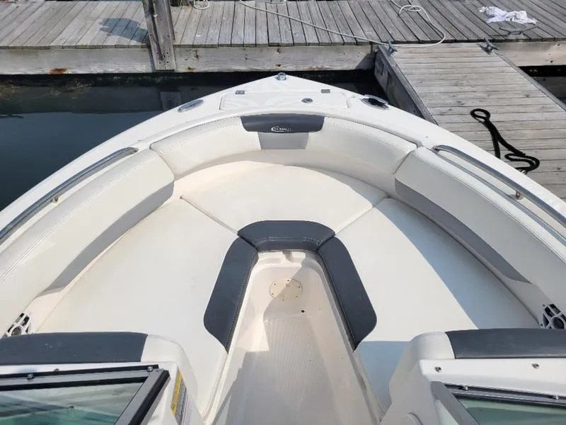 Slide: The Image of 2023 Robalo 227 DC boat with spacious seating at dock. - 6