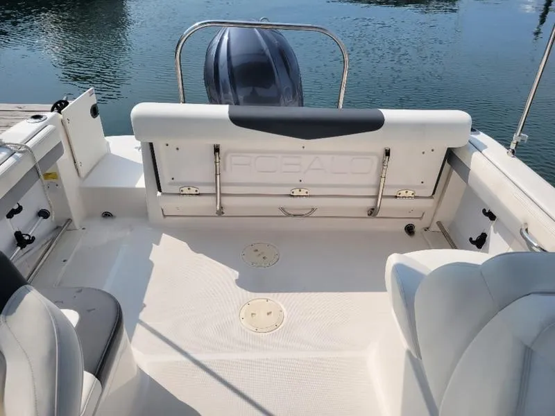Slide: The Image of 2023 Robalo 227 DC boat interior with seating and motor view. - 7