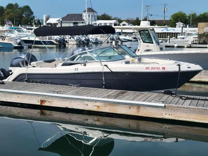 Slide: The Image of 2023 Robalo 227 DC boat docked in marina with canopy. - 9