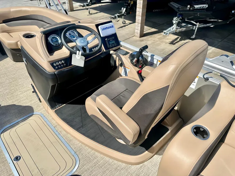 Slide: The Image of 2023 Barletta Cabrio 20Q boat interior with steering console and tan seating. - 14