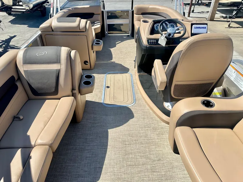 Slide: The Image of 2023 Barletta Cabrio 20Q boat interior with tan seating and steering console. - 6