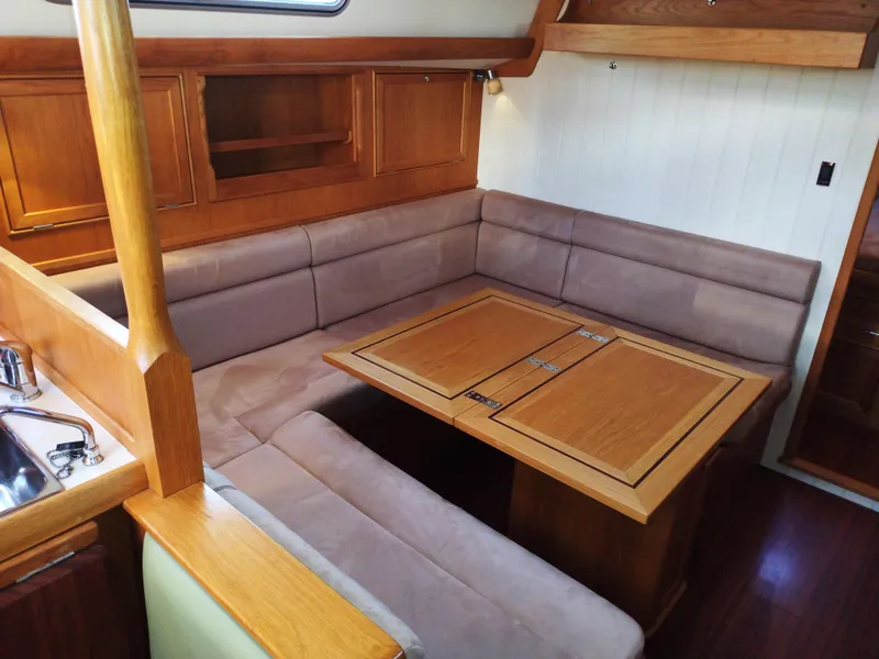 Slide: The Image of Interior of 2015 Rustler 37 yacht with cozy seating and wooden table. - 23