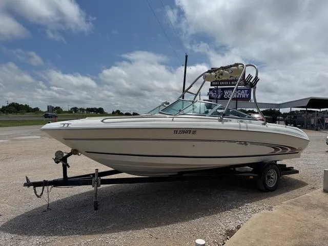 Slide: The Image of 1997 Sea Ray 210 Signature boat on trailer under cloudy sky. - 4
