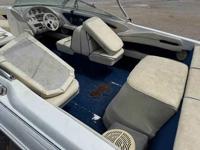 Slide: The Image of 1997 Sea Ray 210 Signature boat interior with worn seats and steering wheel. - 5