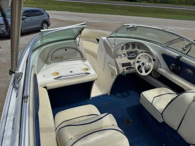 Slide: The Image of 1997 Sea Ray 210 Signature boat interior with white seating and blue accents. - 6