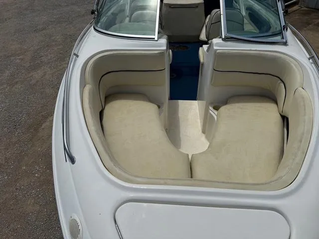 Slide: The Image of 1997 Sea Ray 210 Signature boat with beige seating and open bow design. - 7