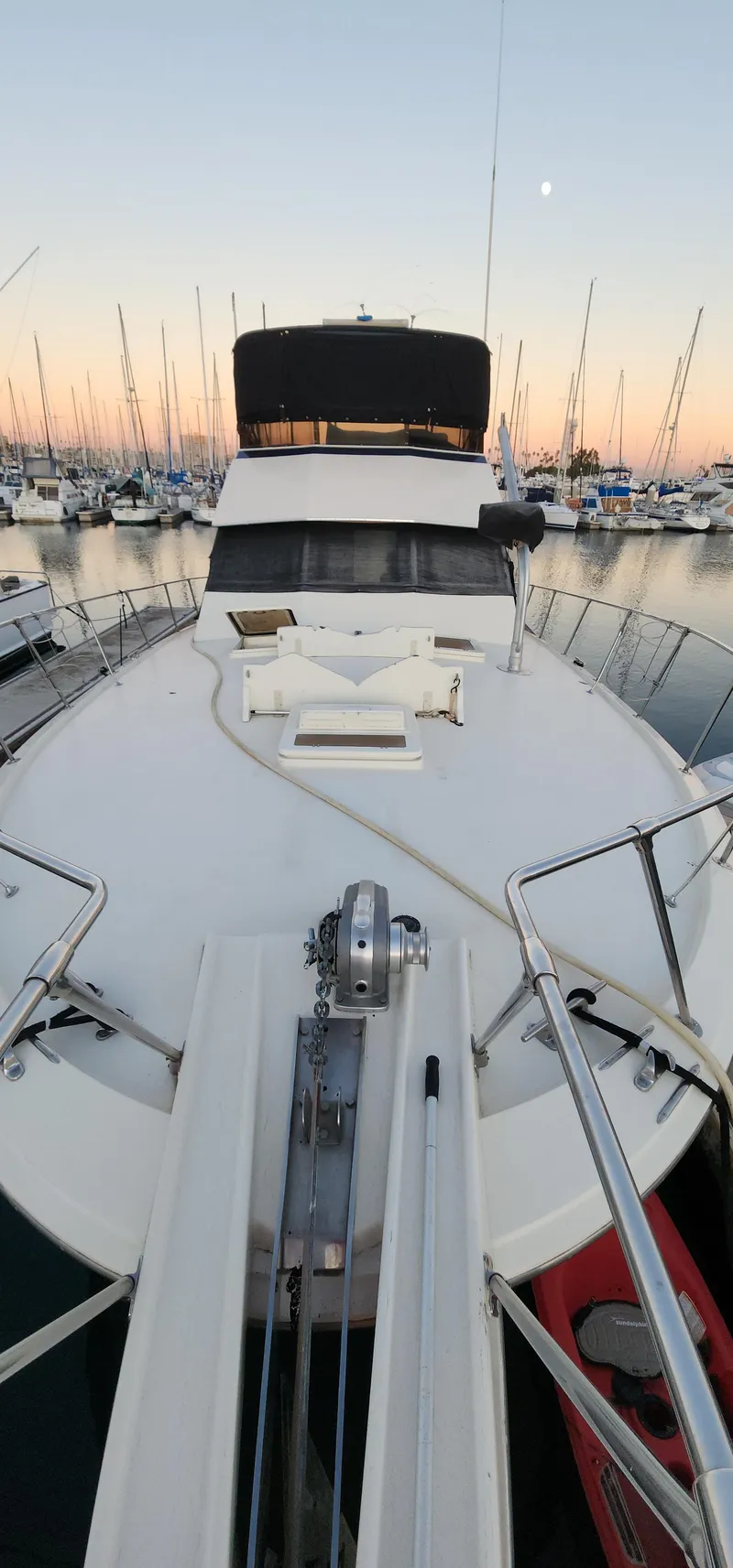 Slide: The Image of 1978 Hatteras Sportfish yacht docked at sunset in a marina. - 10
