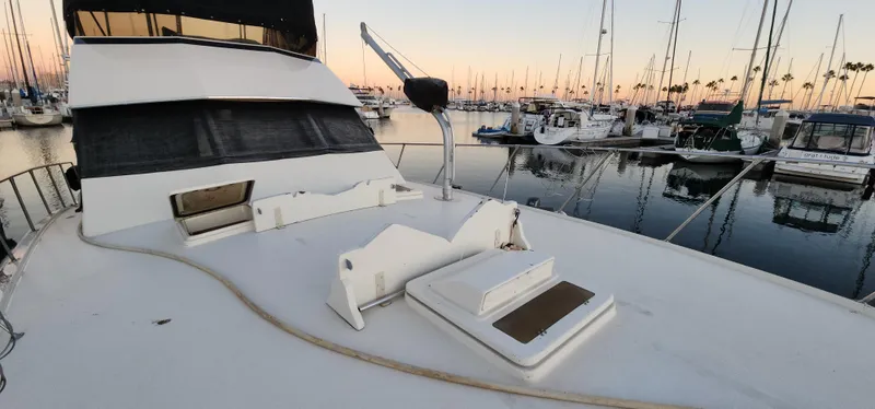 Slide: The Image of 1978 Hatteras Sportfish yacht docked at marina during sunset. - 12