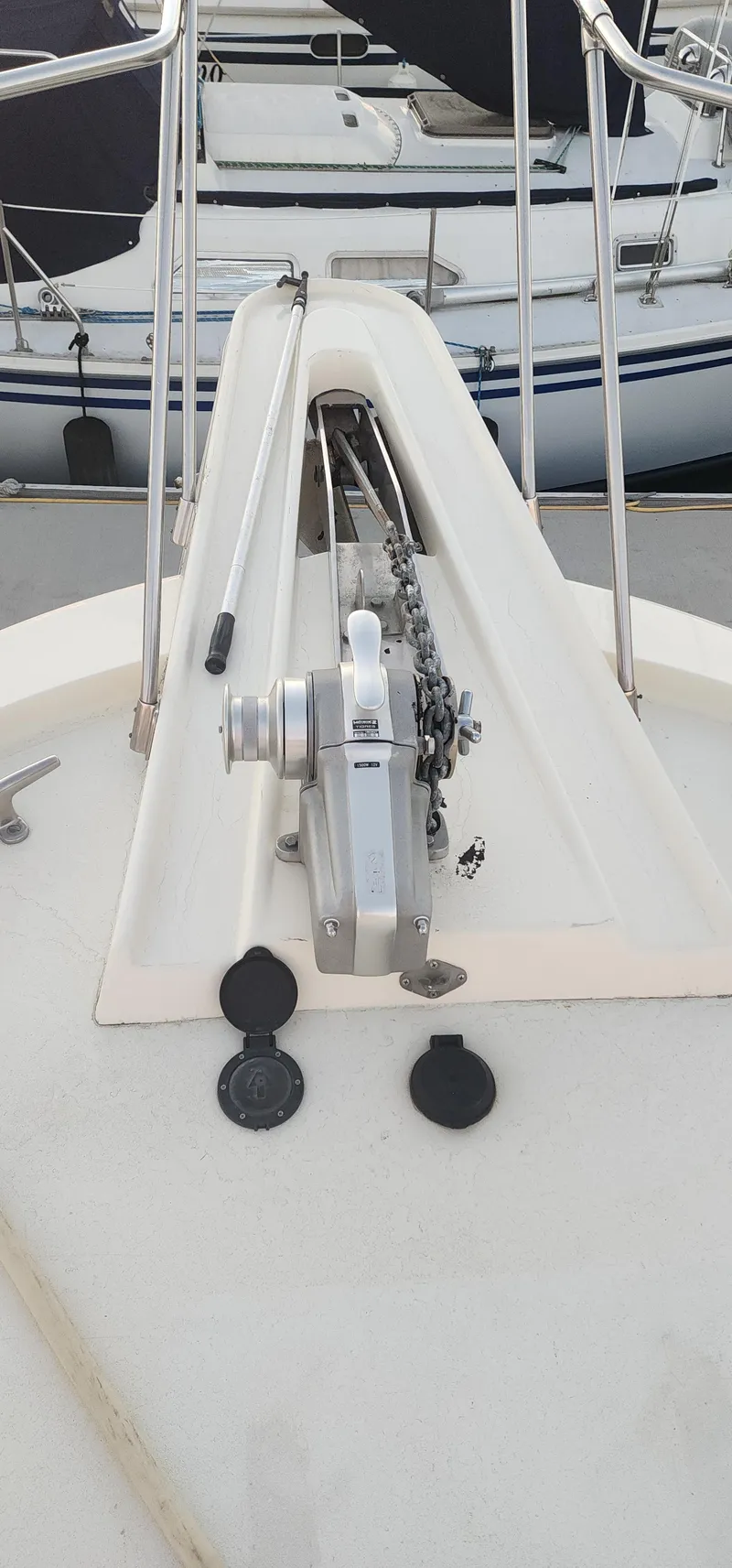 Slide: The Image of 1978 Hatteras Sportfish boat deck with anchor windlass and railing. - 14