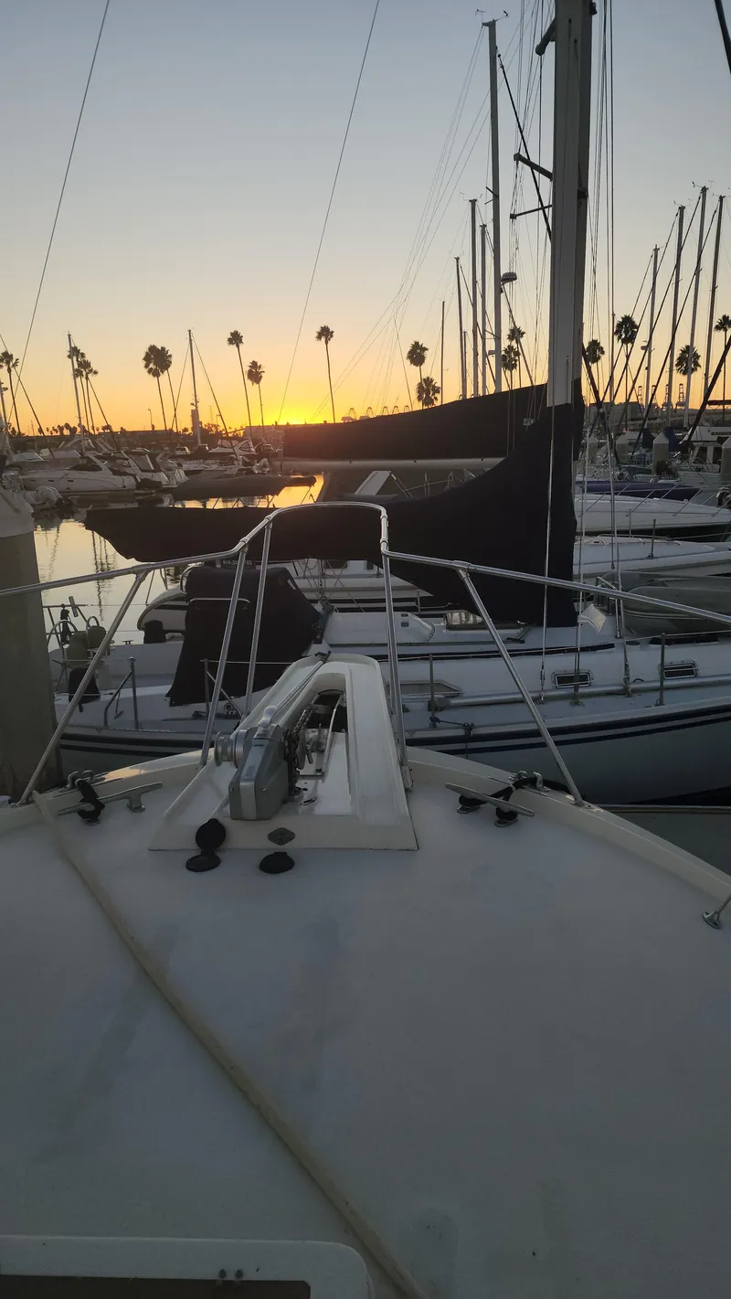 Slide: The Image of 1978 Hatteras Sportfish yacht at sunset in marina with sailboats. - 15