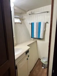 Slide: The Image of 1978 Hatteras Sportfish bathroom with sink, towel rack, and window. - 18