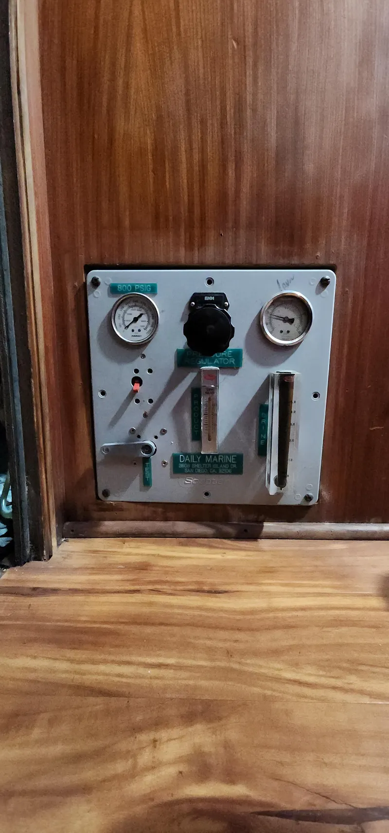 Slide: The Image of 1978 Hatteras Sportfish control panel with gauges and switches on wooden background. - 27