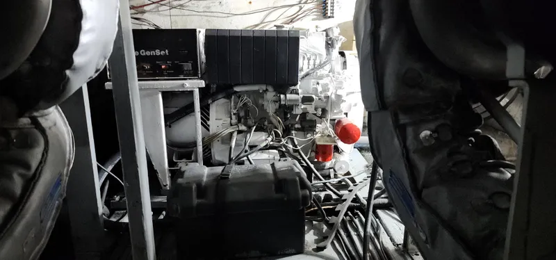 Slide: The Image of Engine room of a 1978 Hatteras Sportfish boat with visible machinery and wiring. - 30