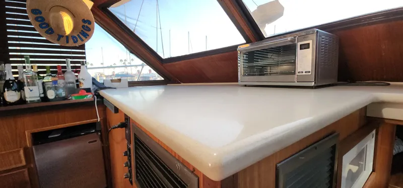 Slide: The Image of 1978 Hatteras Sportfish interior with countertop, toaster oven, and bar setup. - 34