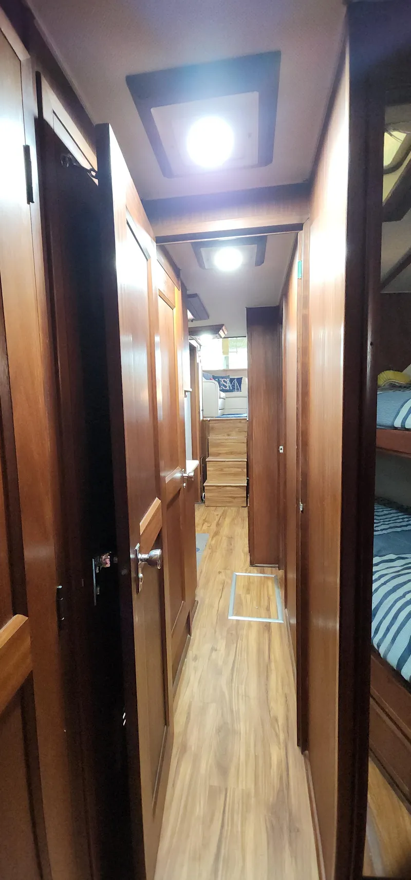 Slide: The Image of Interior hallway of a 1978 Hatteras Sportfish yacht with wooden finishes and bunk beds. - 39