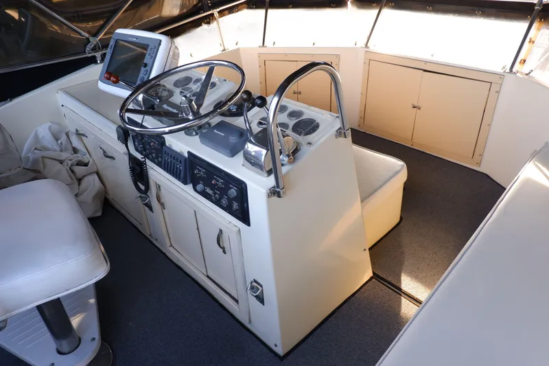 Slide: The Image of 1978 Hatteras Sportfish helm with steering wheel, navigation equipment, and seating. - 7