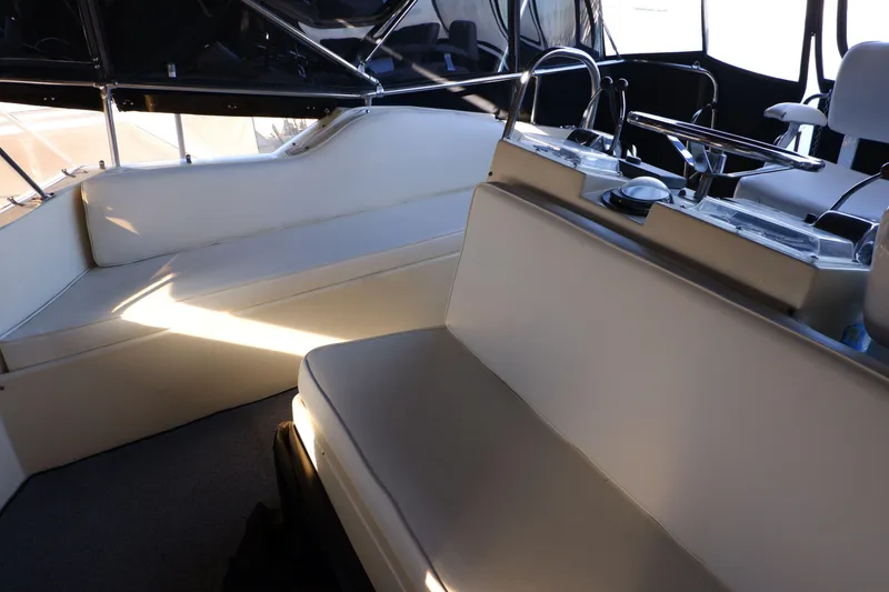 Slide: The Image of 1978 Hatteras Sportfish boat interior with cushioned seating and steering area. - 8