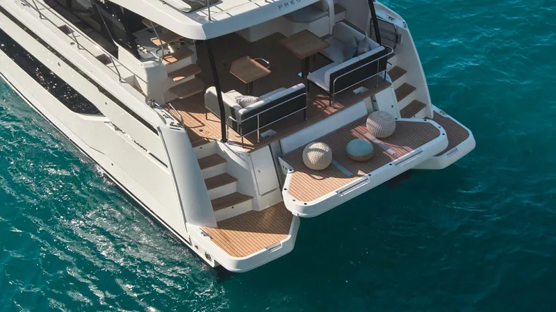 Slide: The Image of 2024 Prestige M48 yacht with spacious deck on turquoise water. - 15